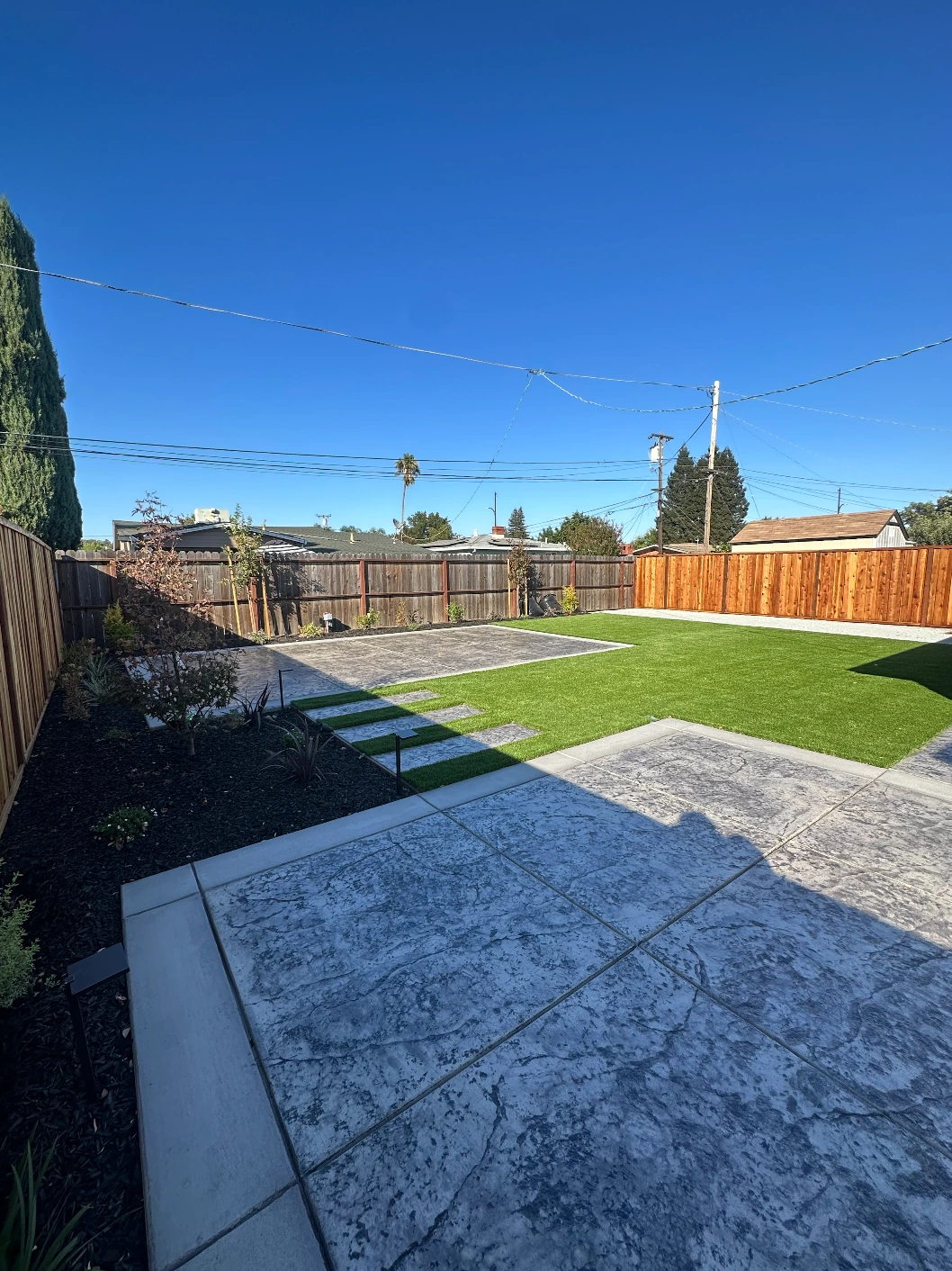 Designed backyard with hardscape, plantings, and outdoor living area